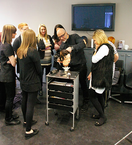 Kiri from Paul Mitchell demonstrating hair cutting at Eltham salon training